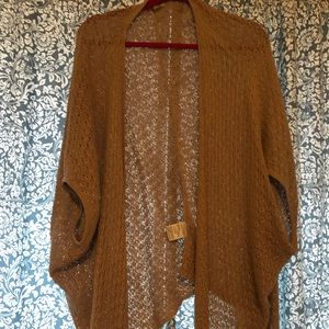 Brown poncho sweater with sleeves.